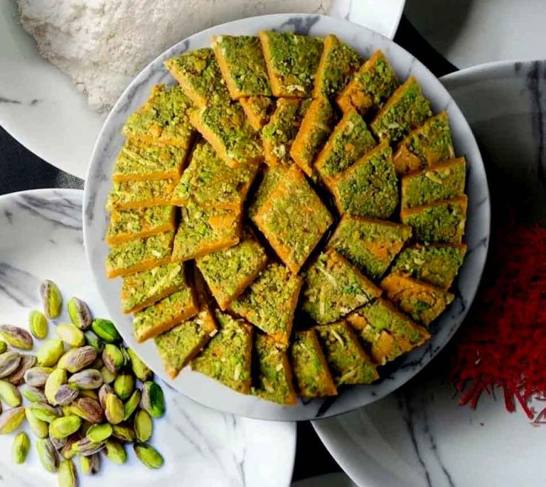 sohan e qom recipe Crispy Persian Sohan brittle topped with green pistachios served on a traditional blue plate