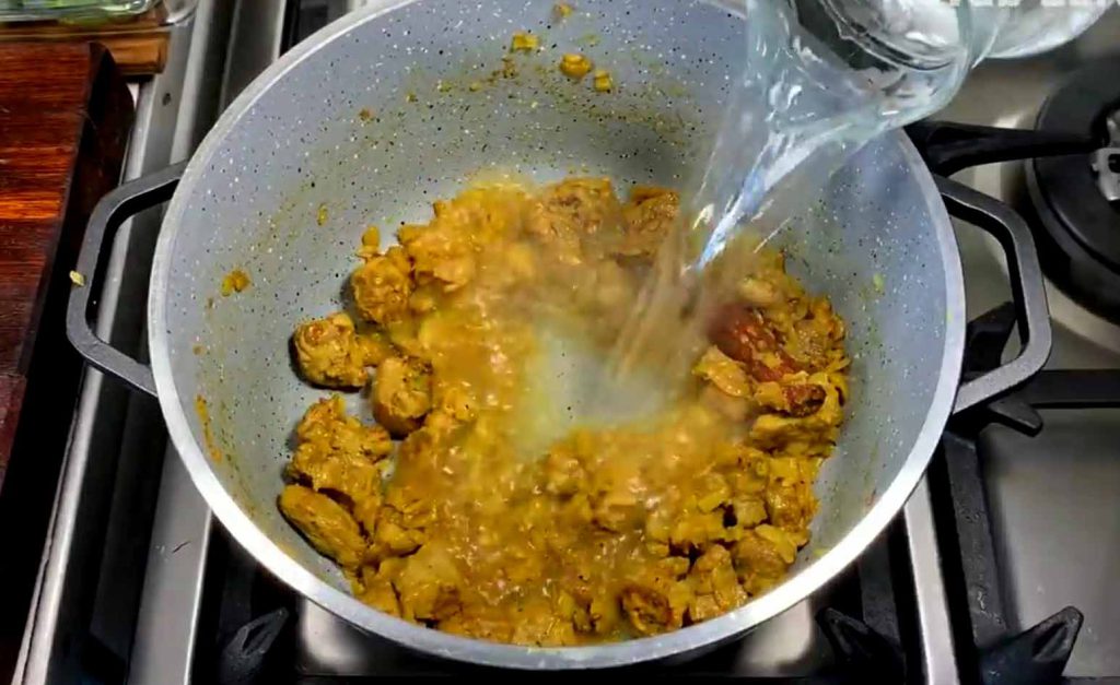 Adding water to the meat mixture to simmer and cook slowly