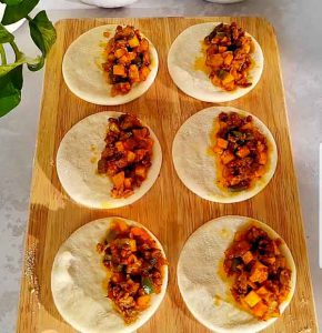 Pour some piroshki ingredients on the molded