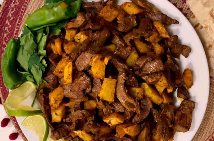 Close-up of Jaghoor Baghoor stew showing texture of cooked lamb liver and onions
