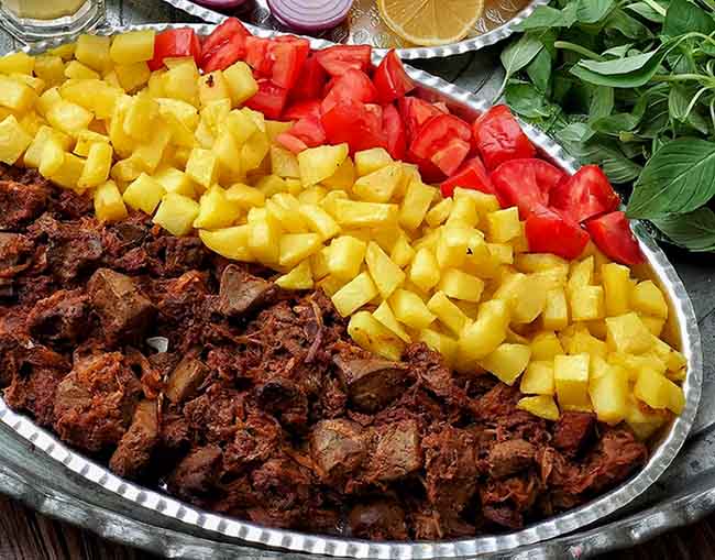 Traditional Persian Jaghoor Baghoor dish served with fresh bread and herbs