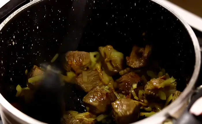 Frying the meat until browned
