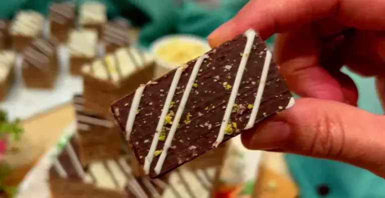 Layered Mikado pastry with dark chocolate coating and white chocolate drizzle