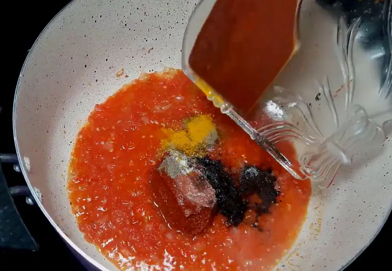 add spices and grated fresh tomatoes